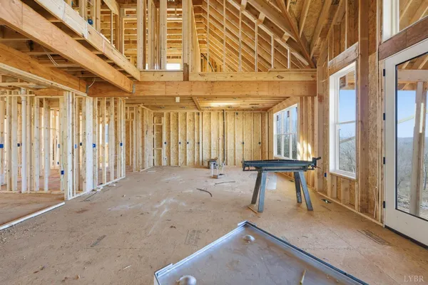 a view of a room with wooden floor and furniture
