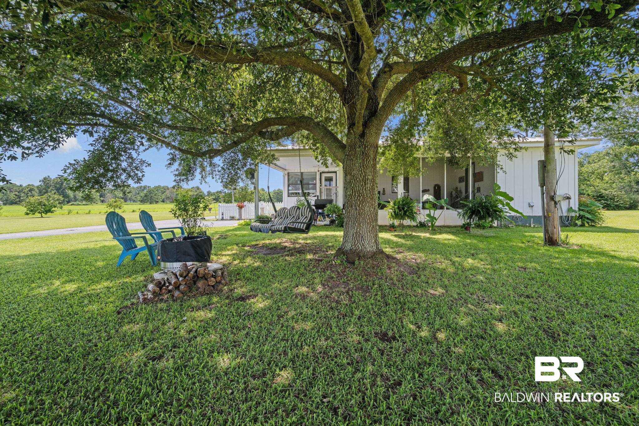 13643 County Road 3 Fairhope, AL 36532 - Photo 32 of 50 Outdoor seating beside screened patio and carport