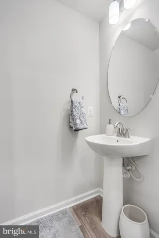 a bathroom with a sink a mirror and toilet