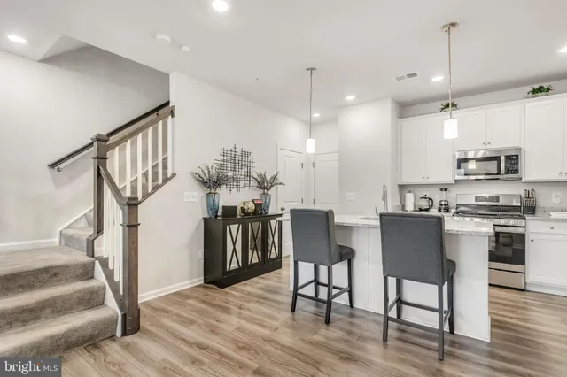 a view of kitchen with furniture and wooden floor