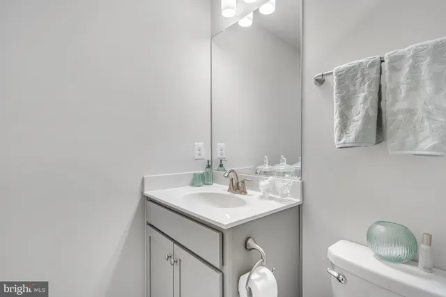 a bathroom with a sink toilet and mirror
