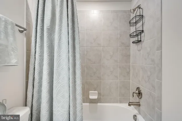 a bathroom with a shower and a bath tub