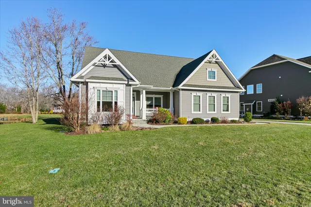 a front view of a house with a garden and porch