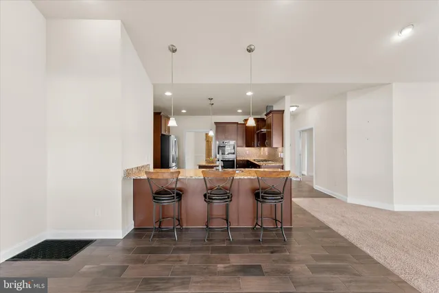 a dining room with furniture and wooden floor
