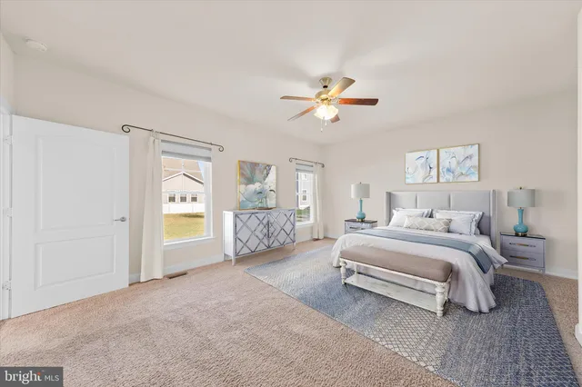 a spacious bedroom with a bed and a chandelier