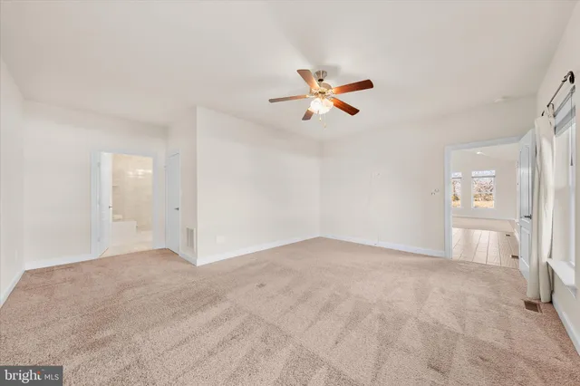 a view of empty room with fan