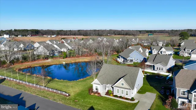an aerial view of a house with swimming pool and lake view