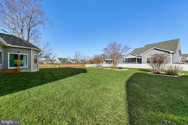 a view of house with garden and tall trees