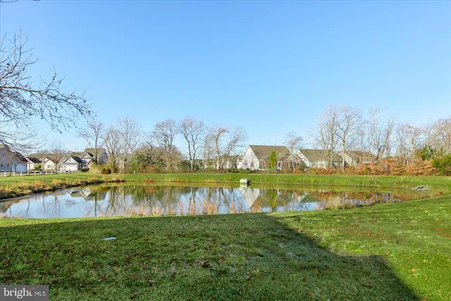 a view of a lake with houses in the back