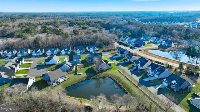 aerial view of a house with a yard and lake view
