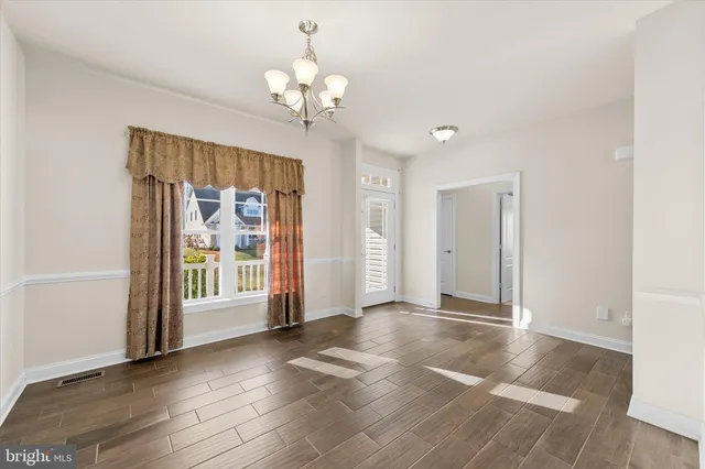 a kitchen with kitchen island granite countertop a sink a counter top space appliances and cabinets