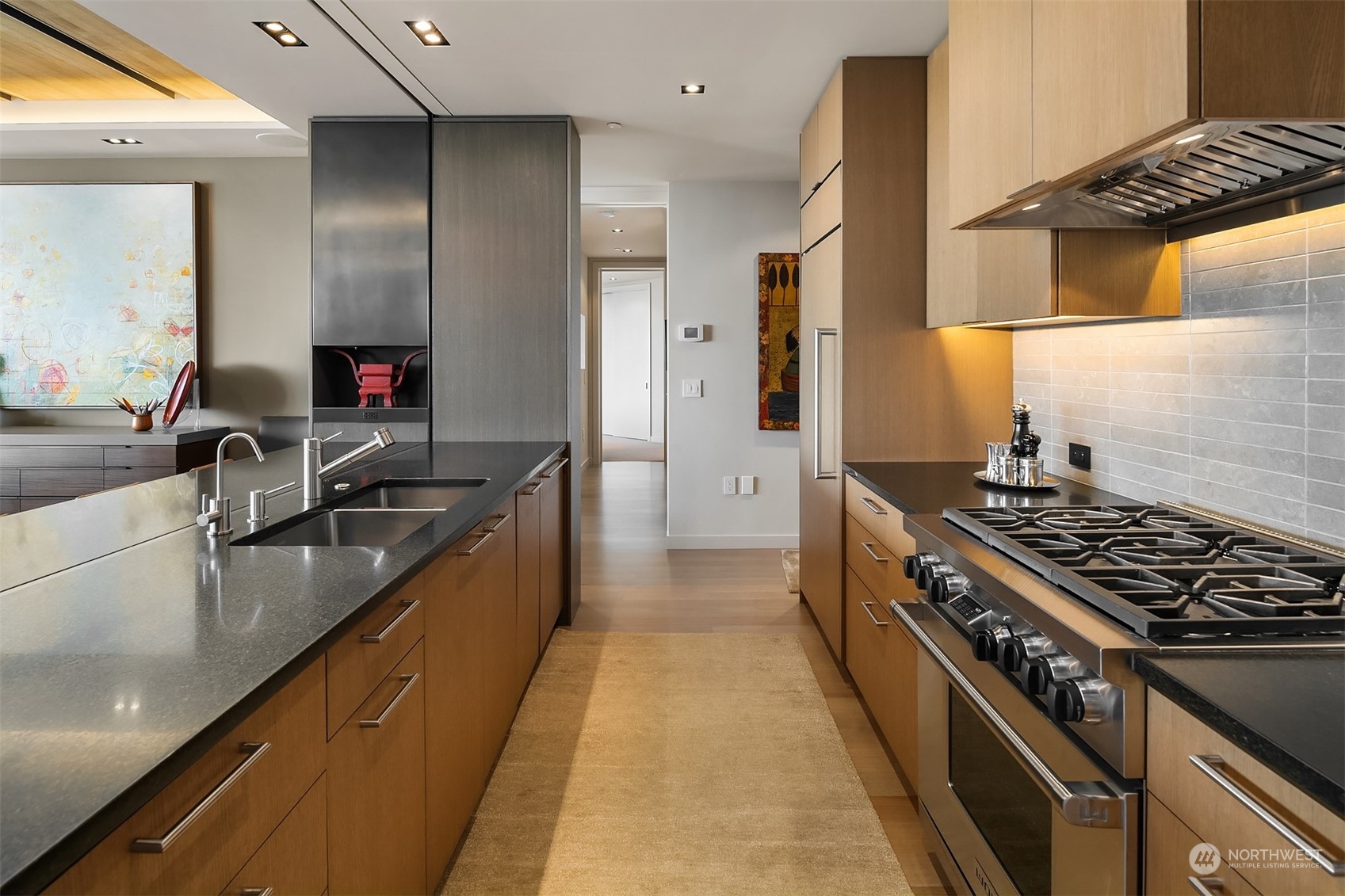 1920 4th Avenue, Unit 2401 Seattle, WA 98101 - Photo 11 of 40 a kitchen with stainless steel appliances granite countertop a sink and a stove top oven