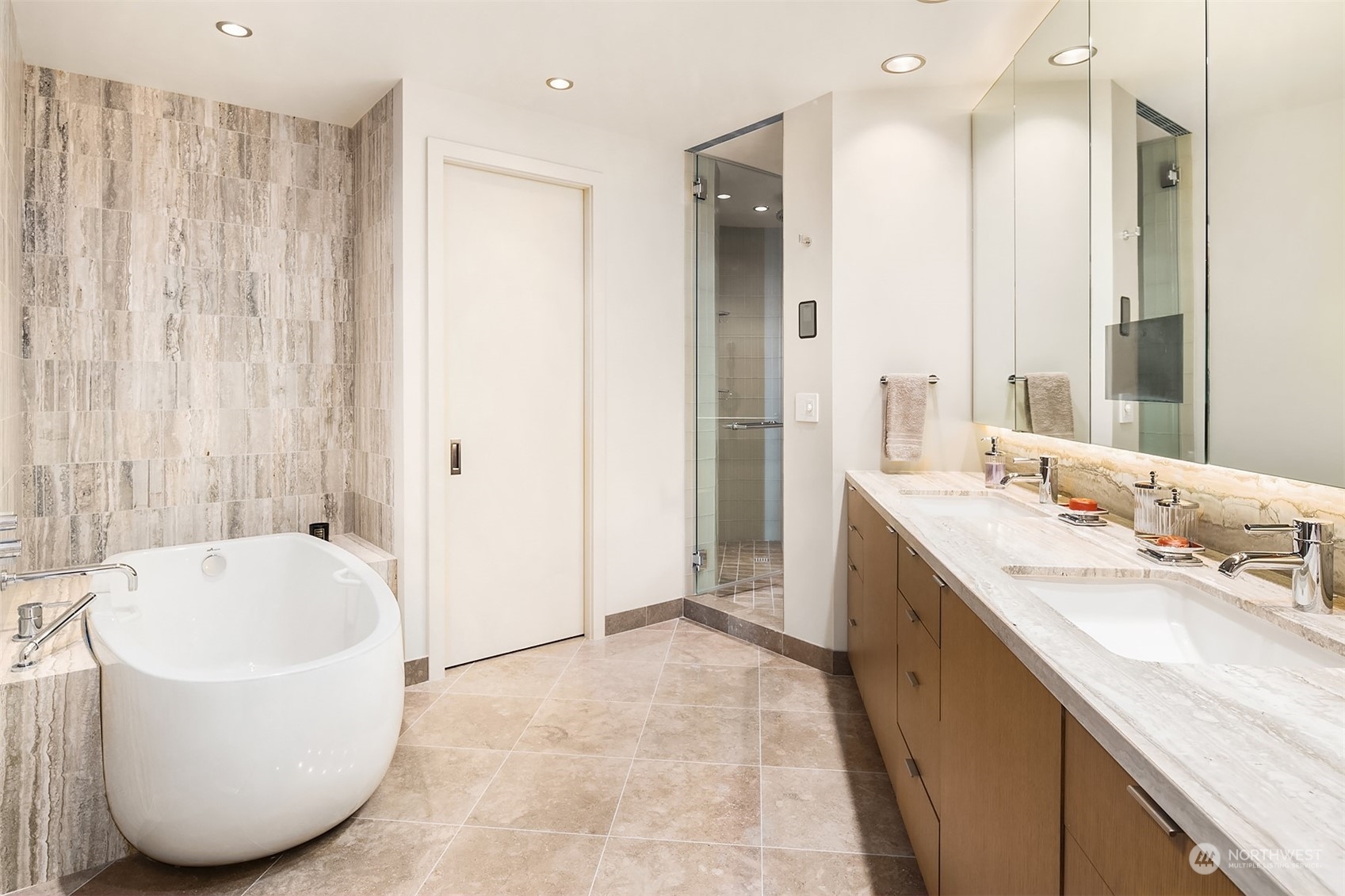 1920 4th Avenue, Unit 2401 Seattle, WA 98101 - Photo 25 of 40 a spacious bathroom with a tub sink and mirror