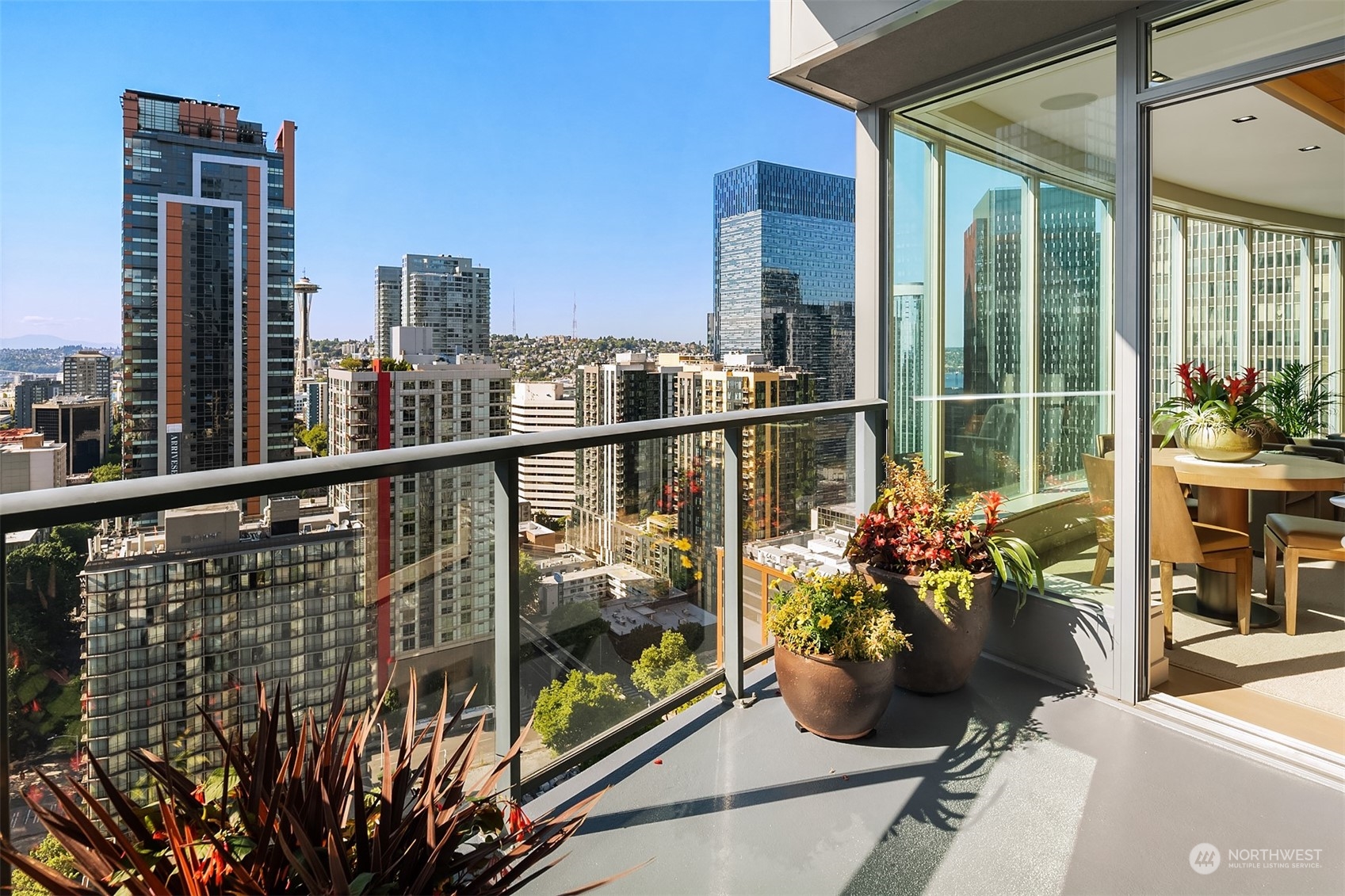 1920 4th Avenue, Unit 2401 Seattle, WA 98101 - Photo 28 of 40 a view of a balcony with chairs potted plants