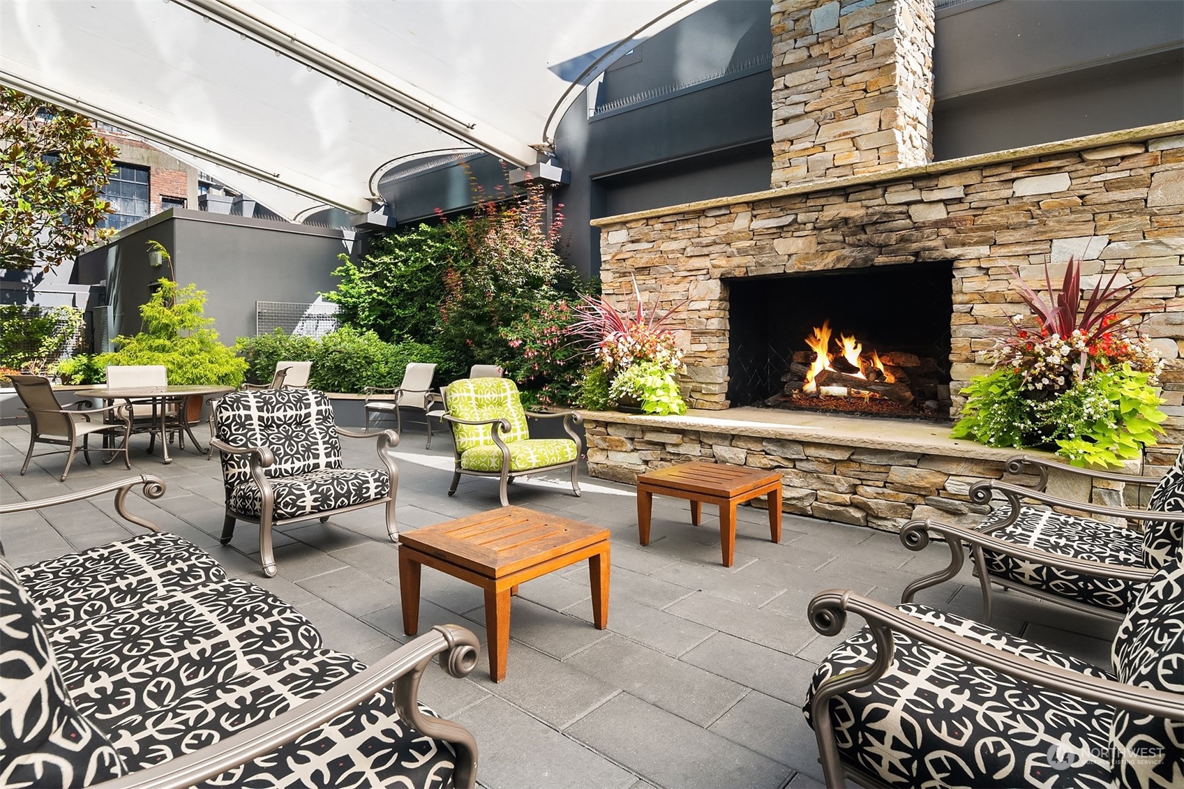1920 4th Avenue, Unit 2401 Seattle, WA 98101 - Photo 39 of 40 a outdoor living space with patio furniture and a fireplace