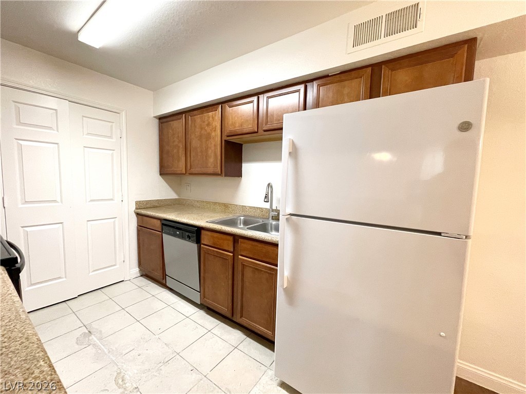 3135 South Mojave Road, Unit 221 Las Vegas, NV 89121 - Photo 7 of 19 An inviting kitchen features a double basin sink and ample cabinetry for culinary ease.