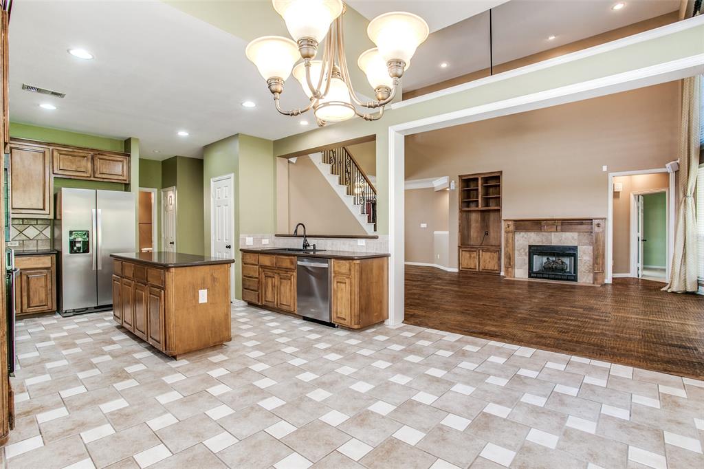 1318 Haddington Lane Keller, TX 76248 - Photo 11 of 37 a living room with fireplace furniture and a kitchen view