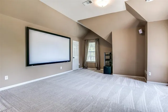 a view of an empty room with window and stairs