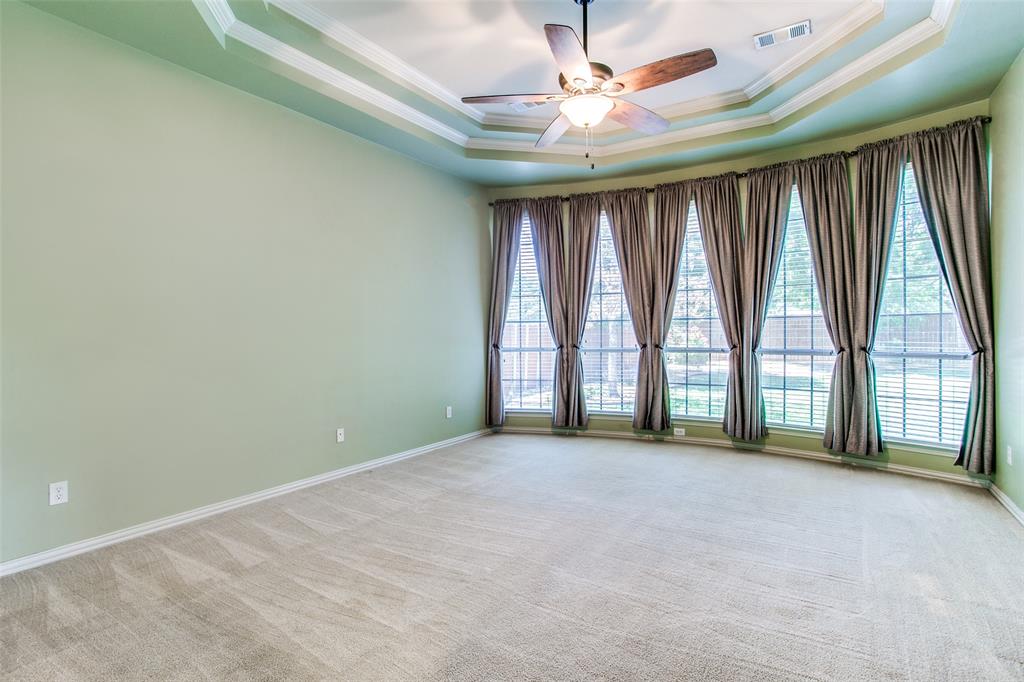 1318 Haddington Lane Keller, TX 76248 - Photo 19 of 37 an empty room with windows and a ceiling fan