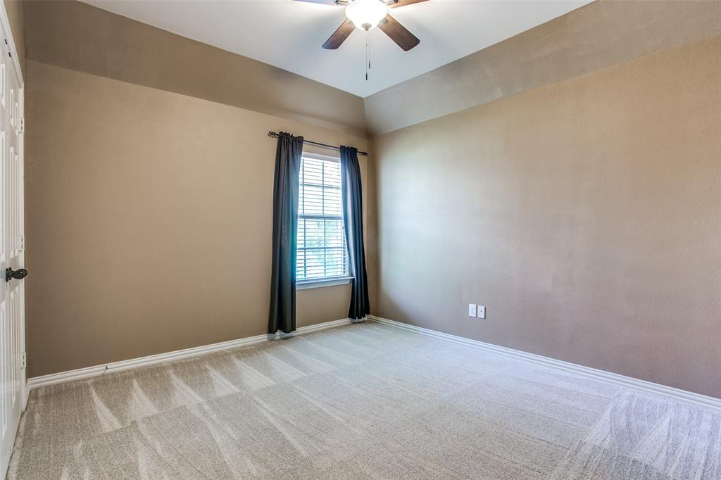 1318 Haddington Lane Keller, TX 76248 - Photo 23 of 37 an empty room with a chandelier fan and windows