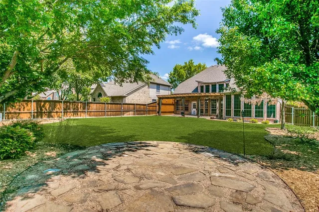 a view of yard with swimming pool and green space