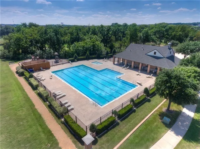 an aerial view of a house with a big yard