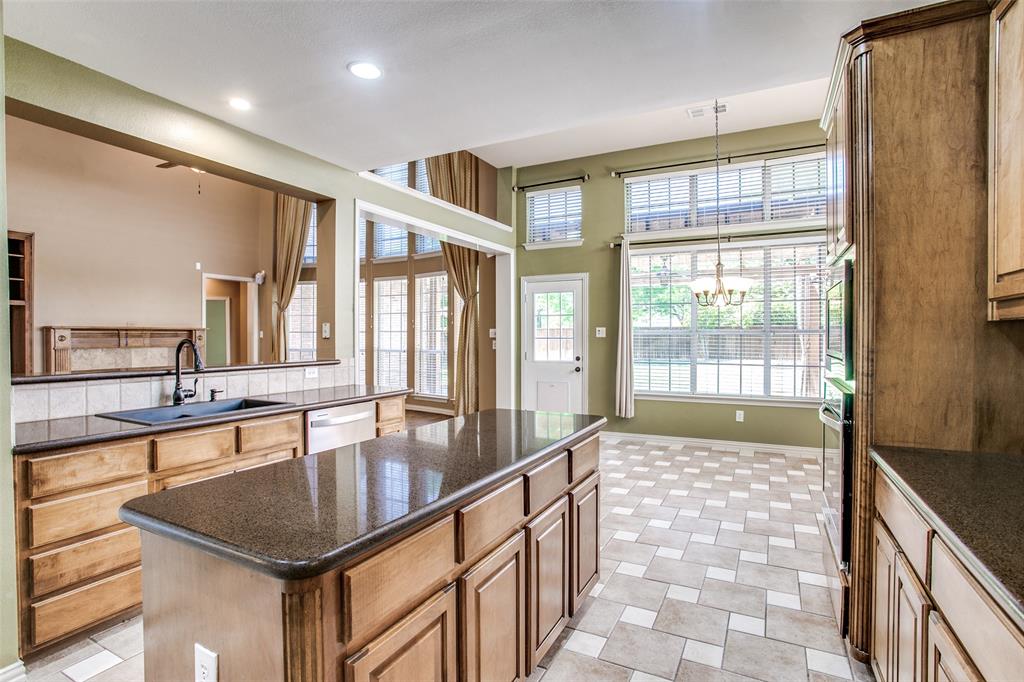 1318 Haddington Lane Keller, TX 76248 - Photo 9 of 37 a large kitchen with kitchen island a large window a sink and stainless steel appliances