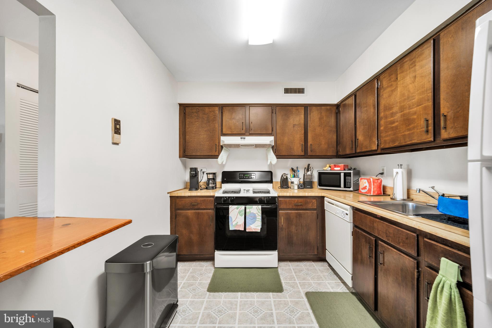 50103 Delaire Landing Road, Unit 50103 Philadelphia, PA 19114 - Photo 12 of 27 a kitchen with stainless steel appliances granite countertop a stove and a sink