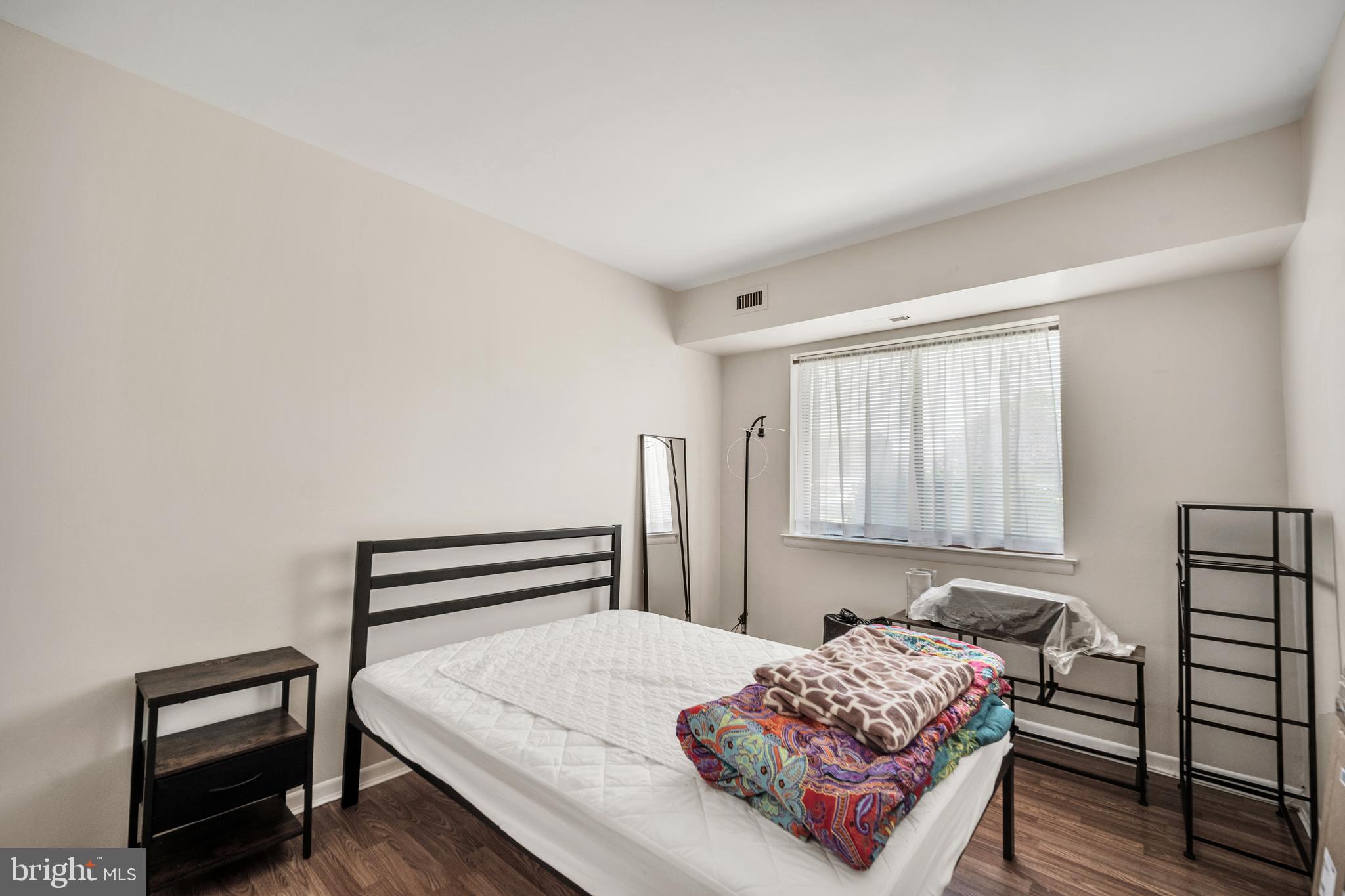 50103 Delaire Landing Road, Unit 50103 Philadelphia, PA 19114 - Photo 16 of 27 a bedroom with a bed and a dresser