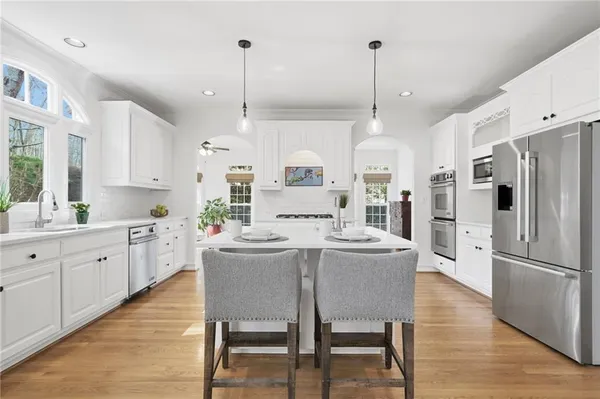 a kitchen with stainless steel appliances a stove refrigerator sink and cabinets
