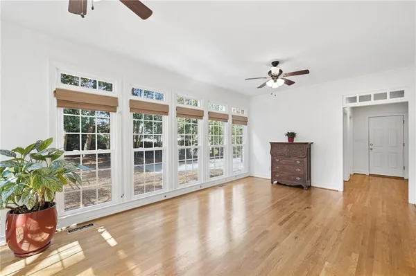 a view of a hallway with wooden floor and entryway