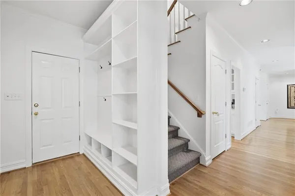 a bedroom with a bed lamp and a large window