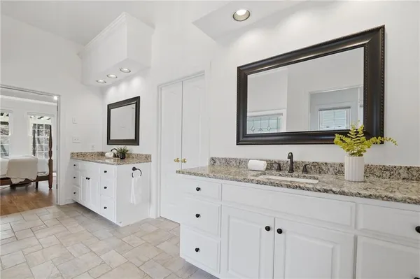 a bathroom with a granite countertop sink a toilet and a mirror