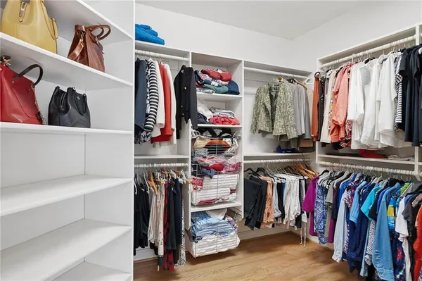 a bedroom with a bed a table and chair