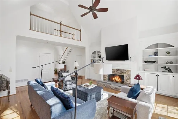 a kitchen with stainless steel appliances granite countertop a dining table chairs stove a refrigerator and cabinets