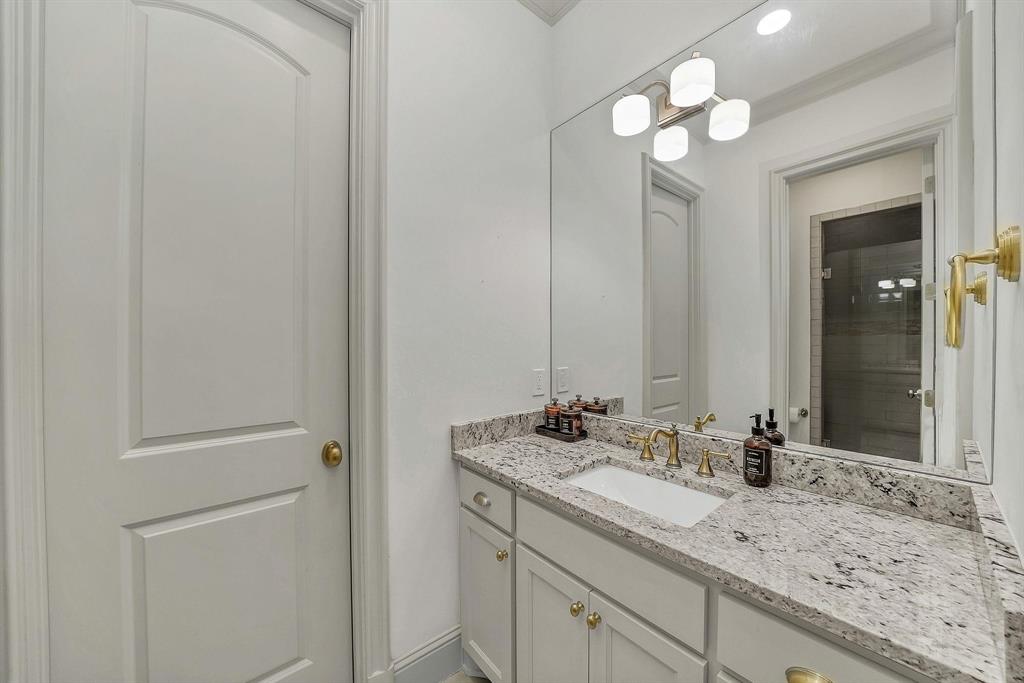 12114 Prestonridge Road Dallas, TX 75230 - Photo 31 of 40 Vanity with a light-toned granite countertop and an undermount sink