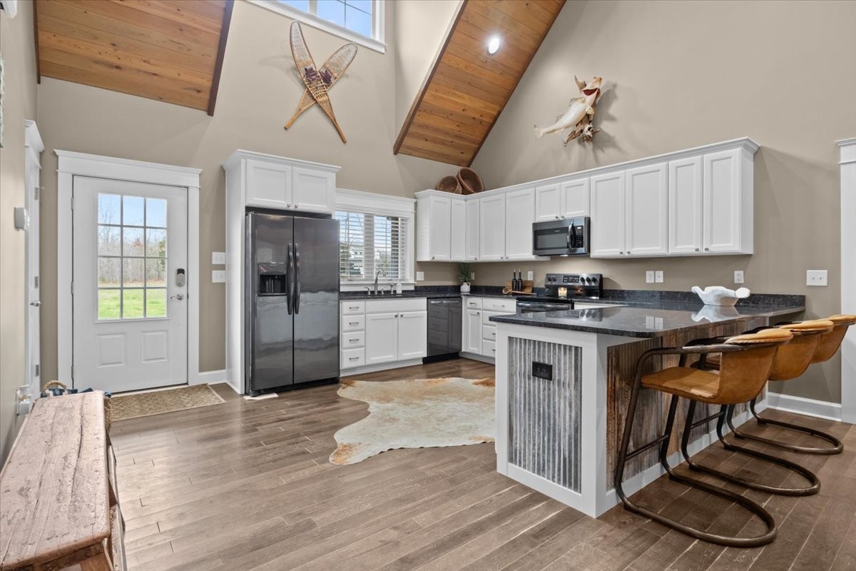 8006 Rose Ridge Pvt Lane Fairview, TN 37062 - Photo 12 of 87 a kitchen with stainless steel appliances granite countertop a stove a sink dishwasher a refrigerator and a microwave oven with white cabinets