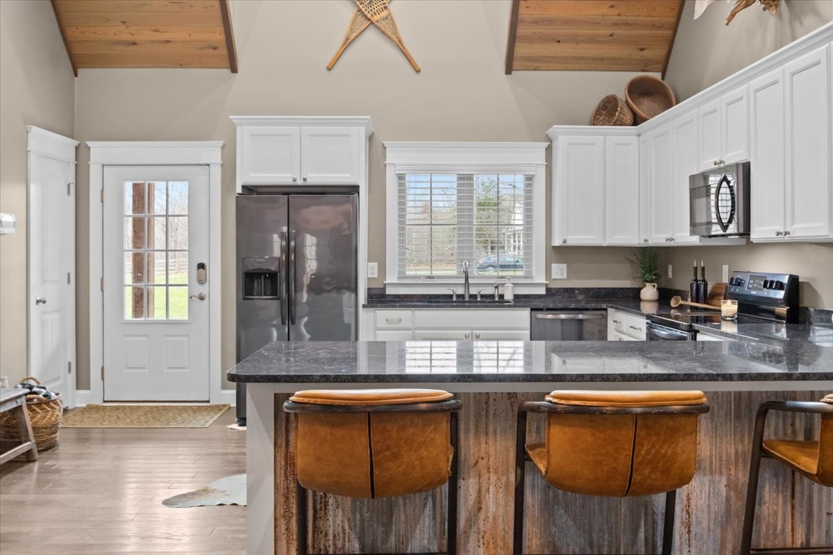 8006 Rose Ridge Pvt Lane Fairview, TN 37062 - Photo 13 of 87 a kitchen with stainless steel appliances granite countertop a stove a sink and a granite counter tops with wooden floors