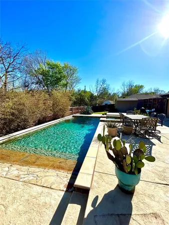 a view of a lake with a floor to ceiling window next to a yard