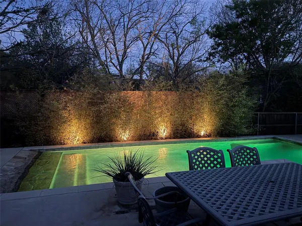 a view of a swimming pool with an outdoor seating and kitchen