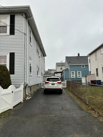 a view of a car park in front of house