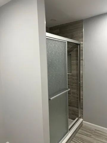 a bathroom with a glass shower door