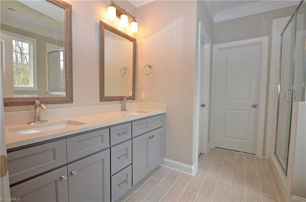 5571 Salem View Road Pfafftown, NC 27040 - Photo 16 of 27 Beautiful master bath has dual sinks, quartz counters, separate tub and shower, and water closet.