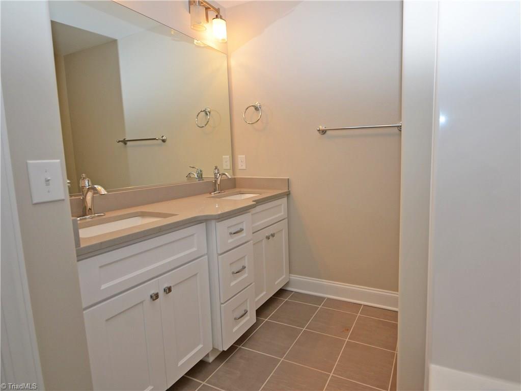 5571 Salem View Road Pfafftown, NC 27040 - Photo 22 of 27 Hall bath has dual sinks and quartz counters.