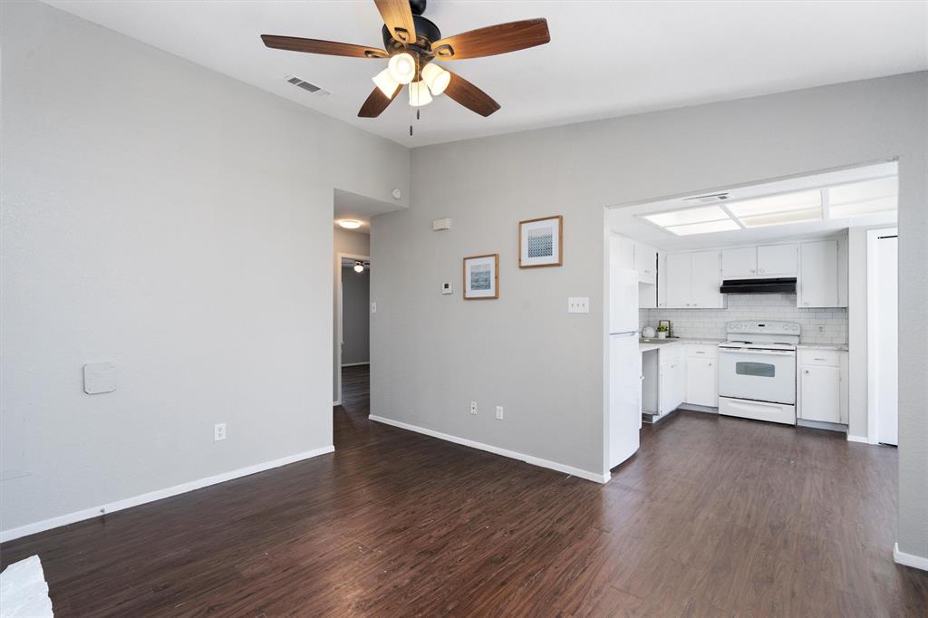1711 Rawhide Loop Round Rock, TX 78681 - Photo 2 of 14 Unfurnished living room featuring dark wood-type flooring and ceiling fan
