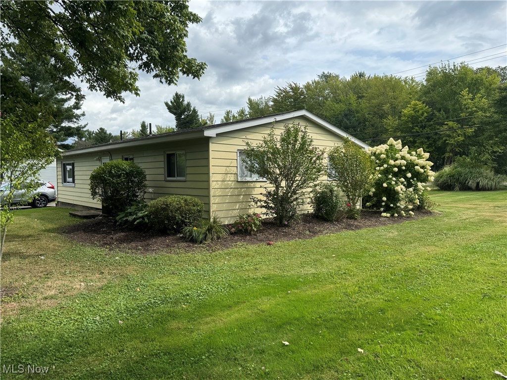 8810 Auburn Road Chardon, OH 44024 - Photo 4 of 22 View of side of home featuring a lawn