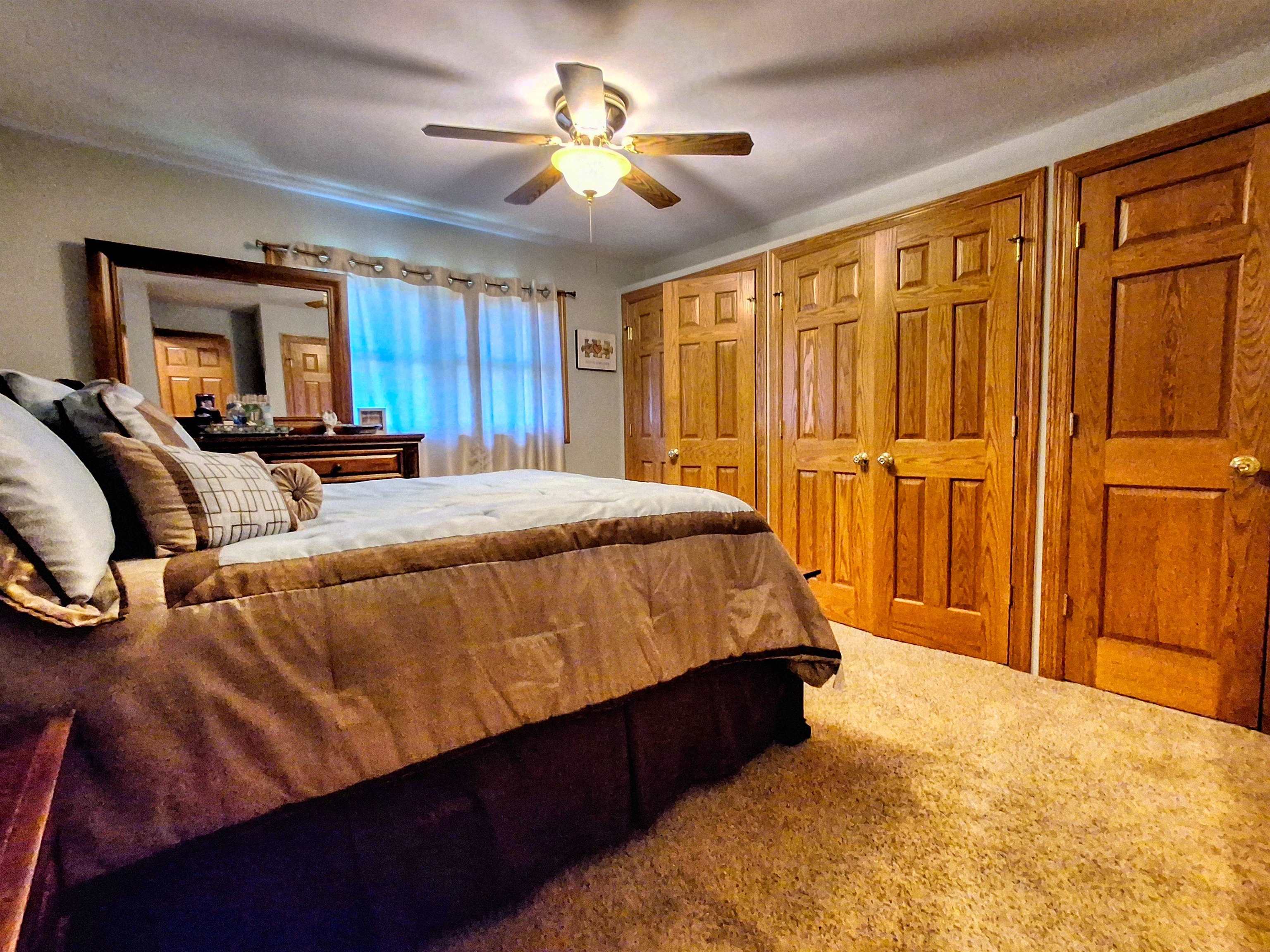 7009 West Pearl City Road Freeport, IL 61032 - Photo 18 of 35 a bed sitting in a spacious bedroom next to a window