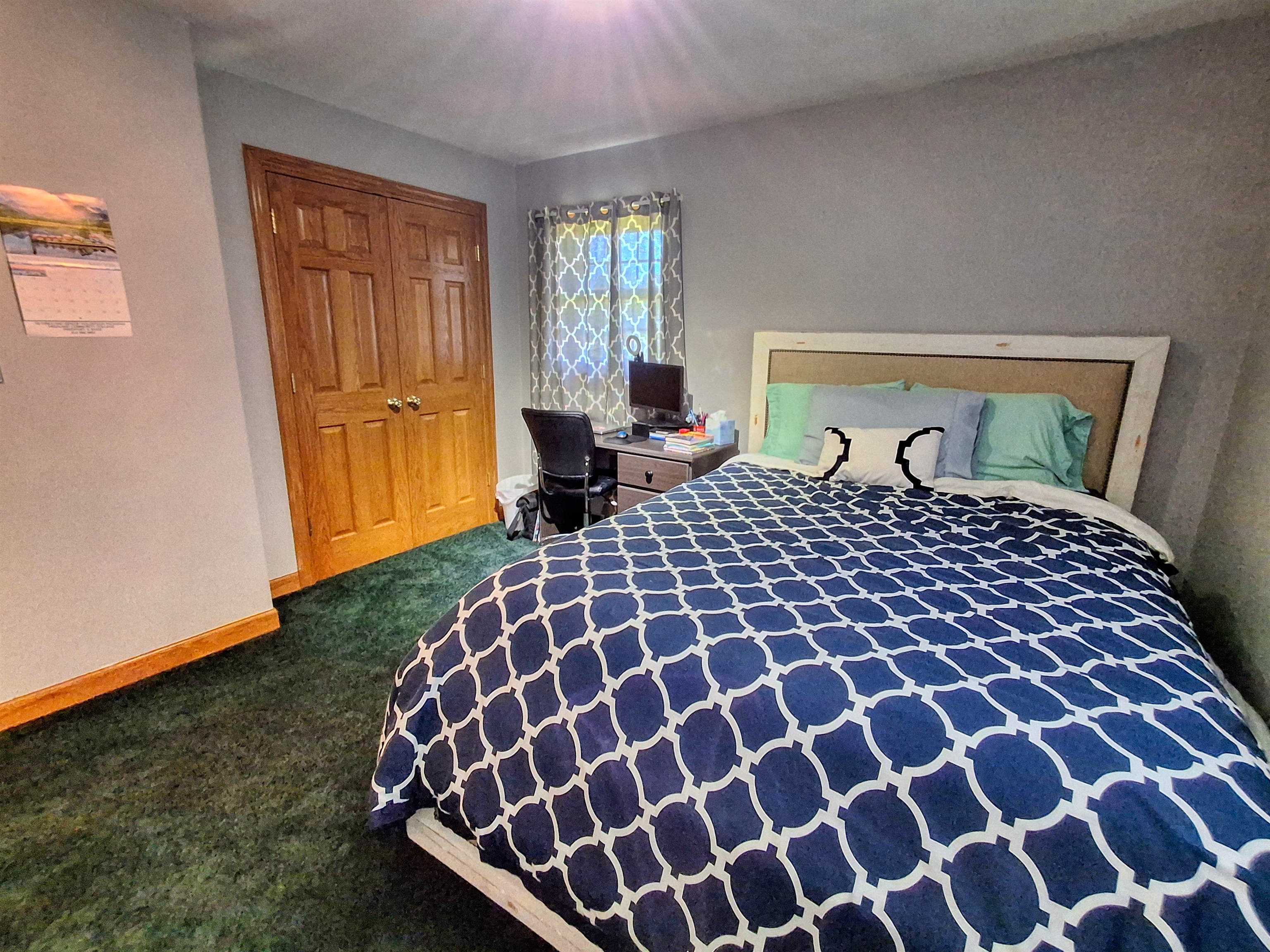 7009 West Pearl City Road Freeport, IL 61032 - Photo 21 of 35 a large bed sitting in a bedroom next to a window and dresser