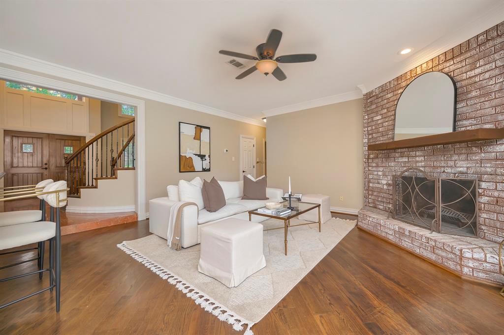 4008 Ramsgate Court Colleyville, TX 76034 - Photo 12 of 33 Living space featuring wood-finish flooring and a brick fireplace with a wood mantel
