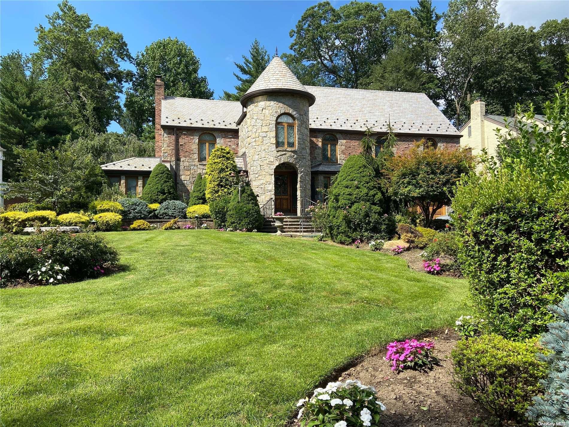 131 Chapel Road Manhasset, NY 11030 - Photo 1 of 1 a front view of a house with a yard and garage